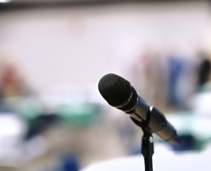 a microphone on a stand with the background blurred